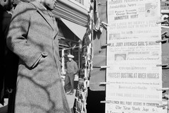 Man passing newspaper stand