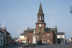 Lochmaben town centre showing the town hall and a statue of Robert Bruce