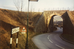 Cwmdauddwr and school signs next to the railway bridge