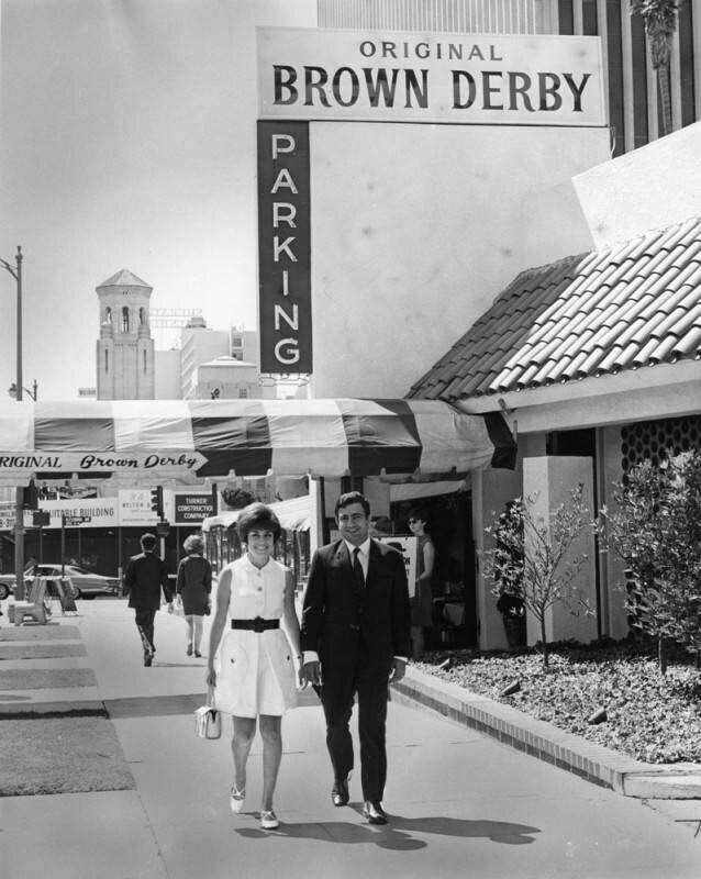 Couple walking from Brown Derby Restaurant