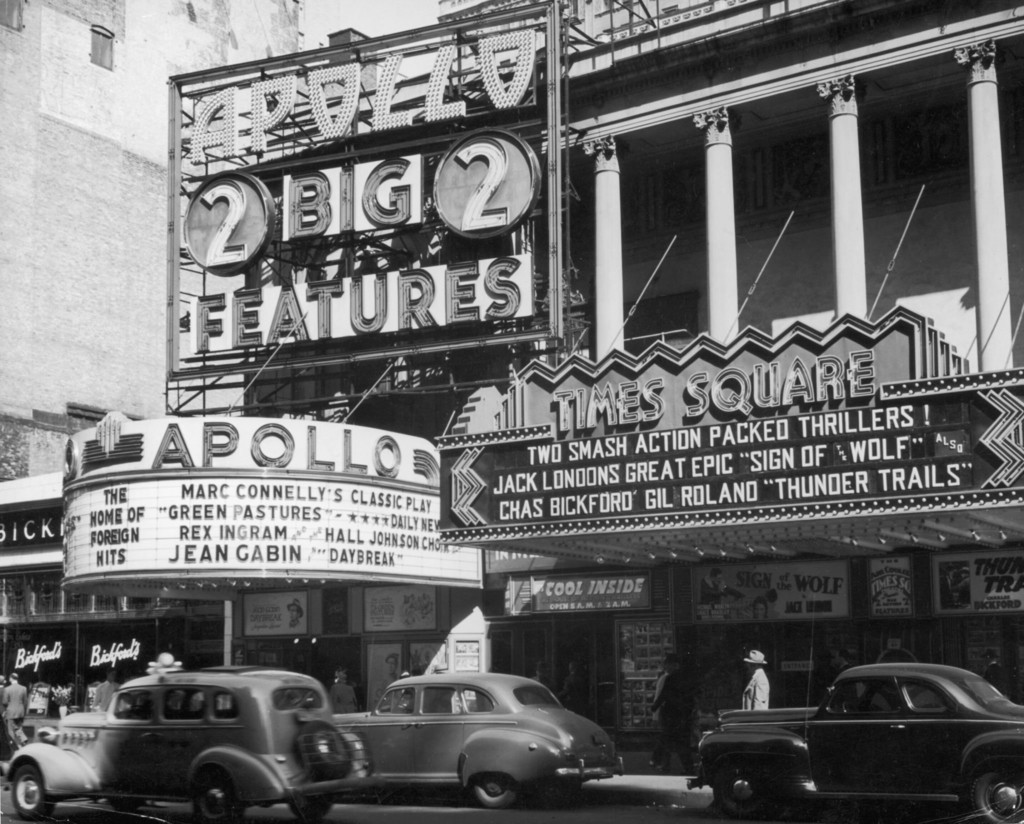 The marquees of the Apollo and Times Square theaters in the midtown neighborhood