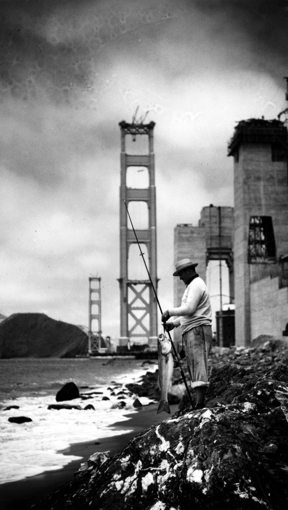 Man fishing, partial Golden Gate Bridge in background