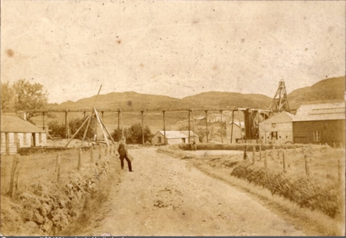 View of the mines at Ystumtuen with a young man in the foreground