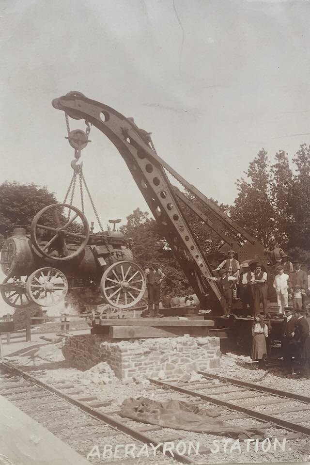 Lowering a locomotive on the track with a crane in Aberayron