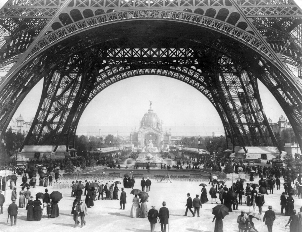 Paris Exposition, view from ground level of the Eiffel tower with Parisians promenading