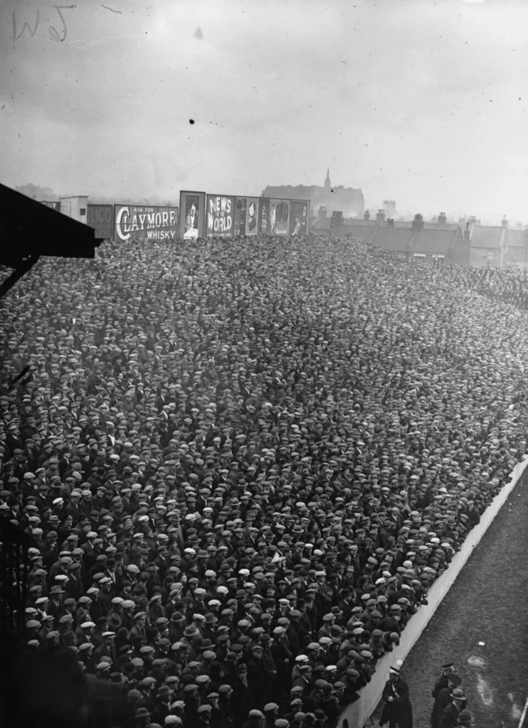 Crowds of hat-wearing football fans West Ham United at Boleyn Ground