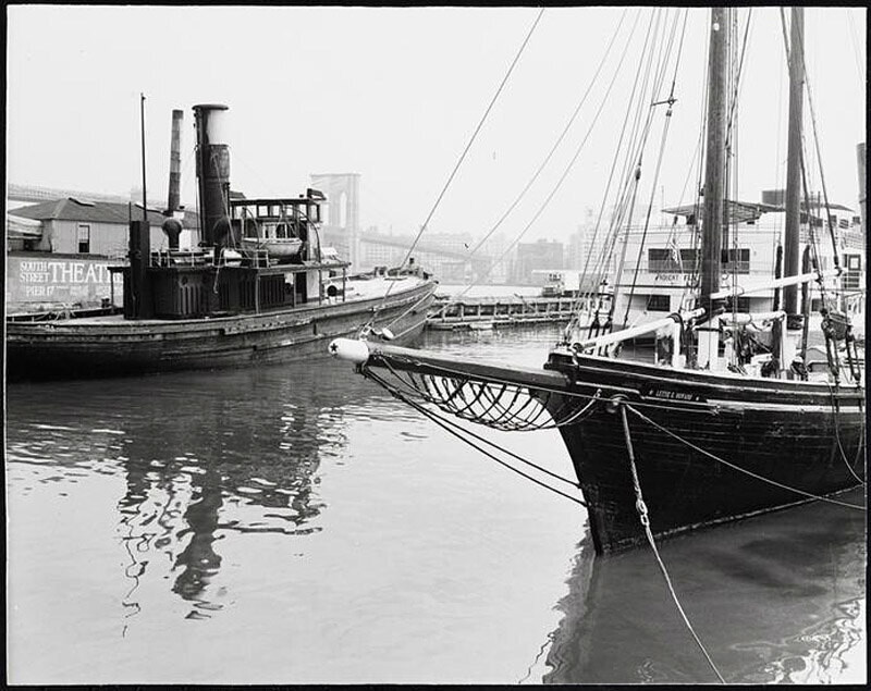 Tugboat and the vessels Robert Fulton and Lettie G. Howard docked at piers 15-17