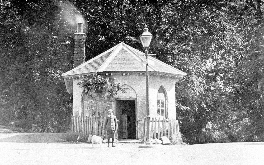 A boy standing outside the tollgate house