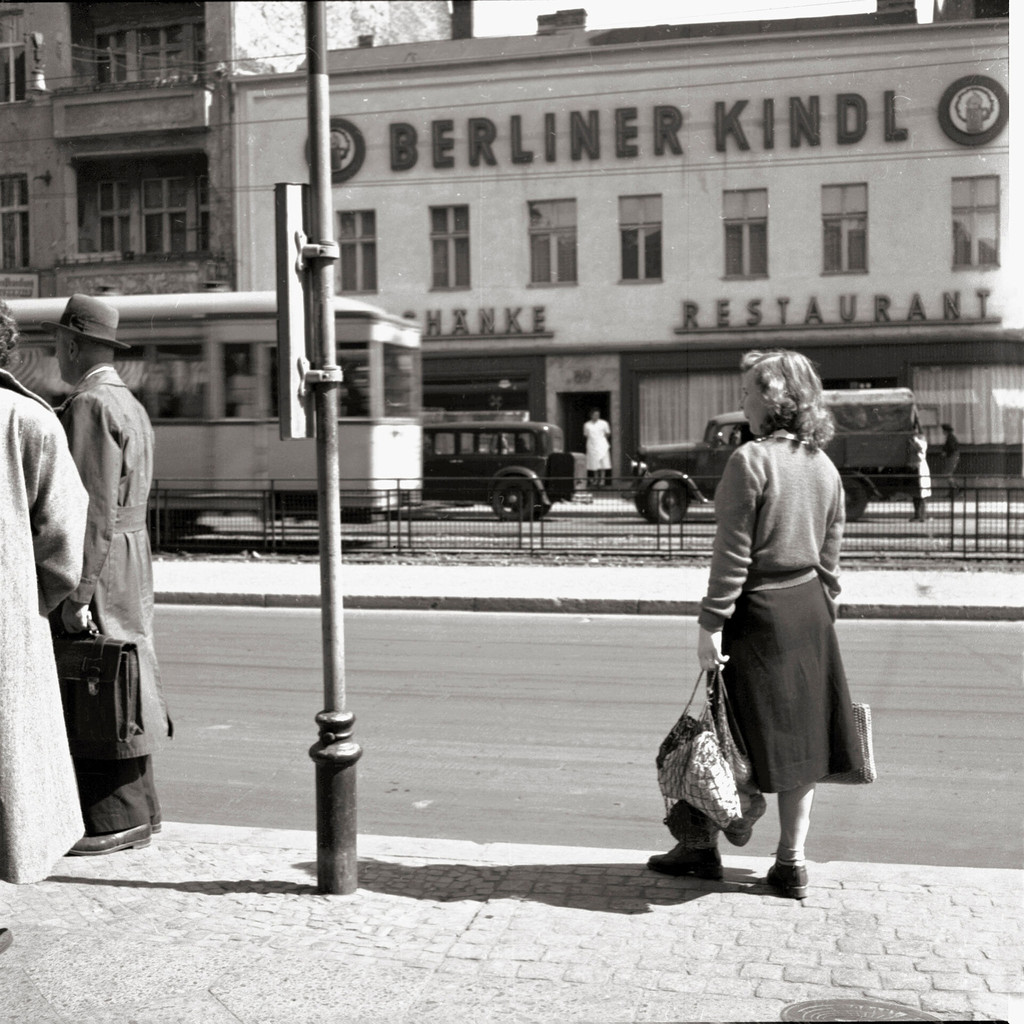 People at a bus station at the Schloßstraße 89