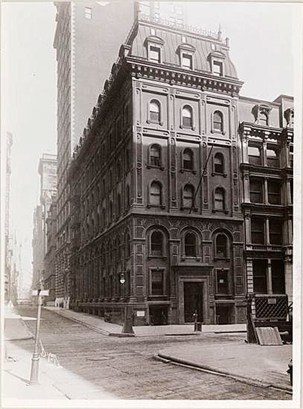 The corner of Wall Street and William Street, shows a building with interesting stone detailing.