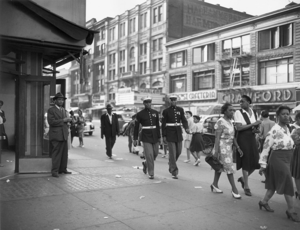Two african-american marines walk down West 125th Street