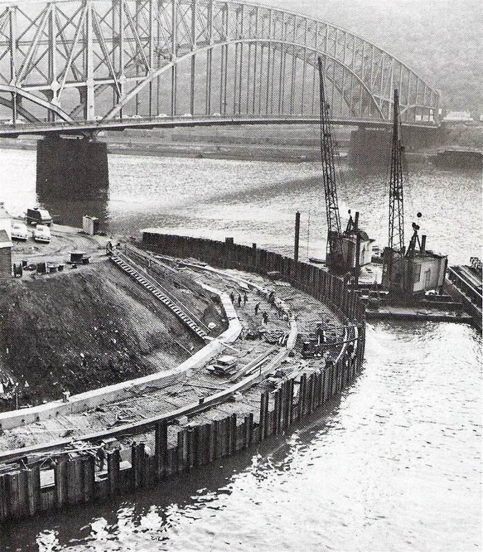 Construction workers building the wall at the tip of Pittsburgh's Point