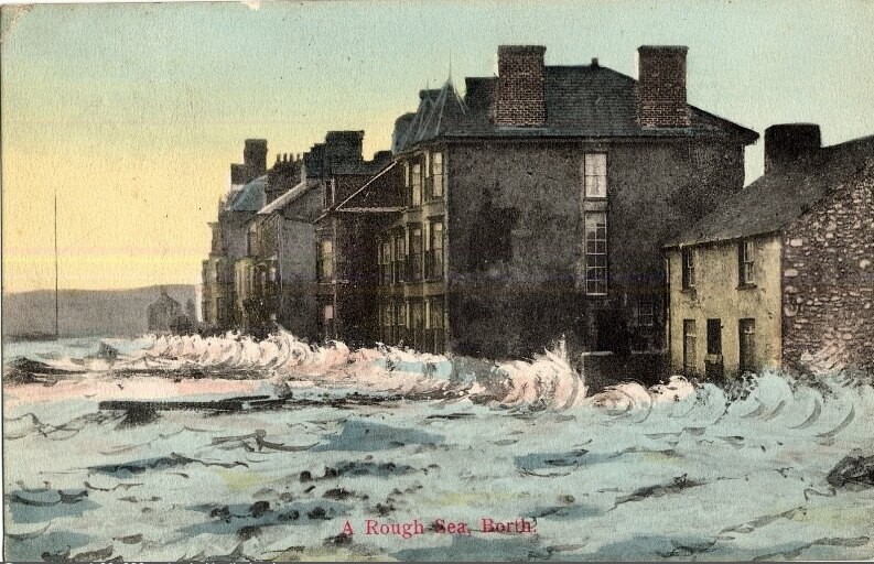 A rough sea flooding Borth high street