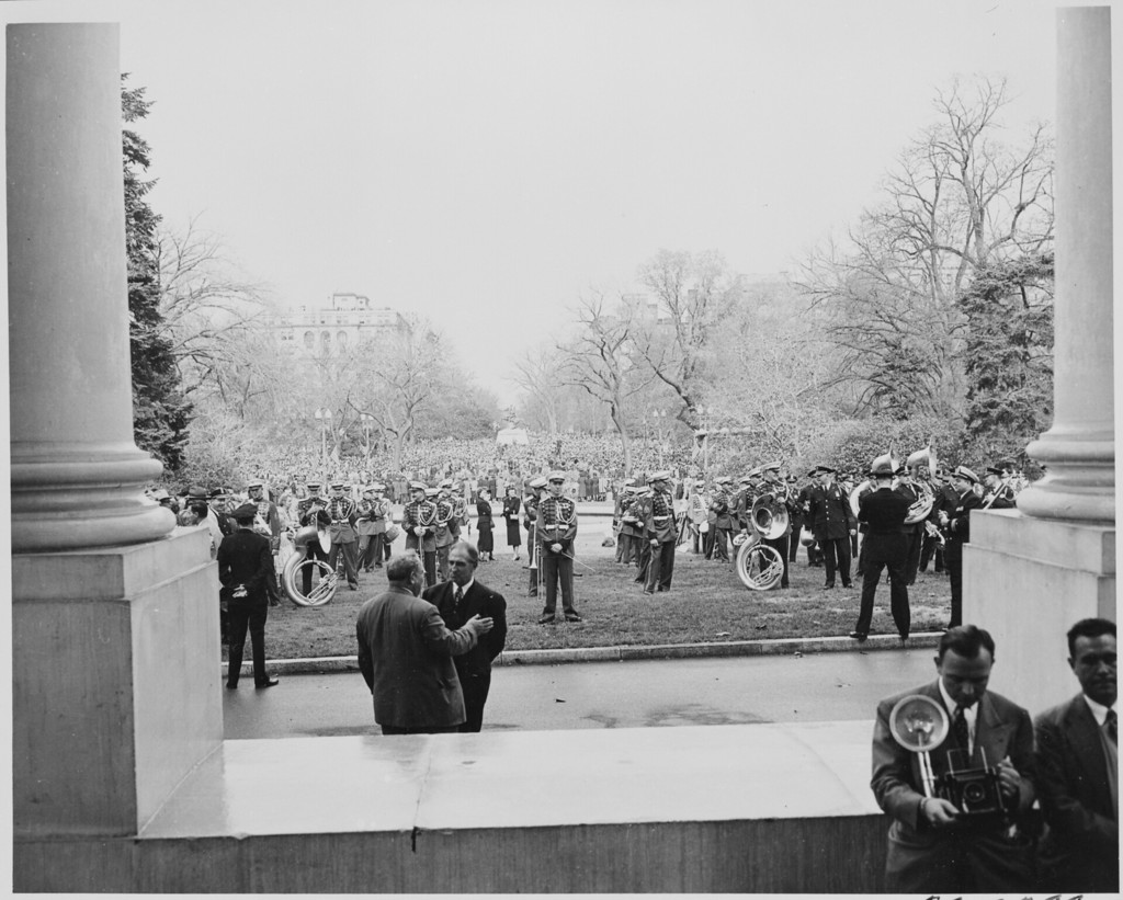 A military band standing on the front lawn of the White House