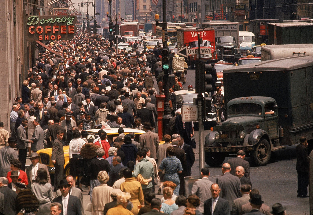 Crowded sidewalks and traffic along 7th Avenue in the Garment District