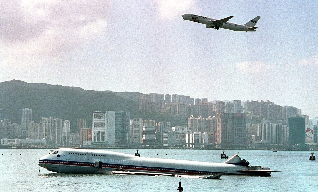 Plane passes above a China Airlines 747 that crashed in the harbour