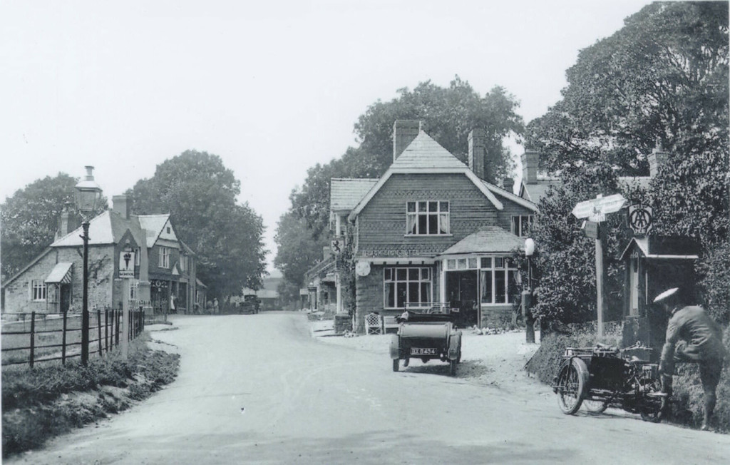Llangurig square with a car and an early motorbike