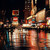 Wet street and neon lights at night Times Square