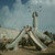 Manila. Young children slide from and climb on a blue structure on the playground